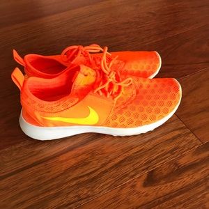 Neon orange Nike sneakers